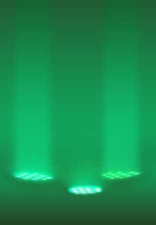 Three bright green spotlight on the pool bottomの写真素材