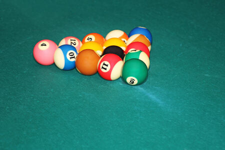 Billiards balls in triangle on the green cloth tableの写真素材
