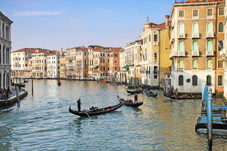 Four gondolas transporting tourists  in the canal Grande perform at the most famous European Carnival on February 14, 2010 in Venice  Gondolas are the best famous symbol of Venice の写真素材