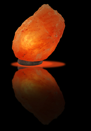 Piece of Himalayan salt as a lamp with reflectionの写真素材