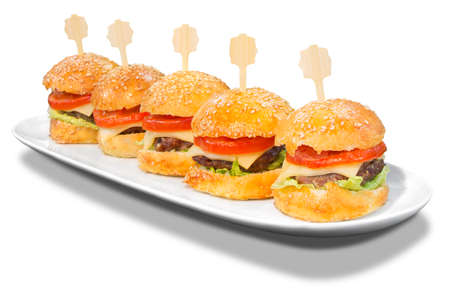 Small hamburgers on a plate, isolated on white background with Clipping Pathの写真素材