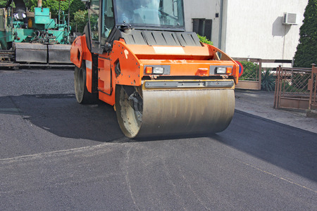 Compactor roller during road construction at asphalting workの写真素材
