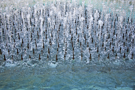Water stream splashing from the many fountains pipeの写真素材