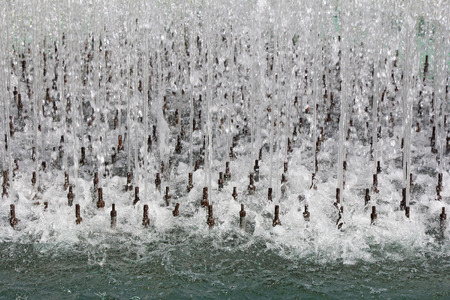Water stream splashing from the many fountains pipeの写真素材