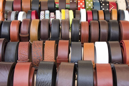 Set of different and colorful leather belts as a background の写真素材