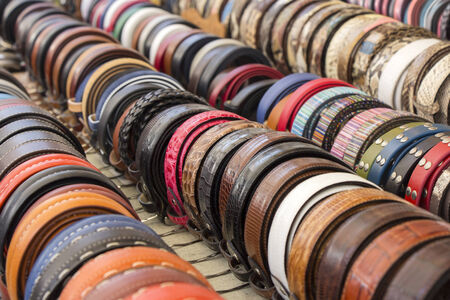 Set of different and colorful leather belts as a background の写真素材