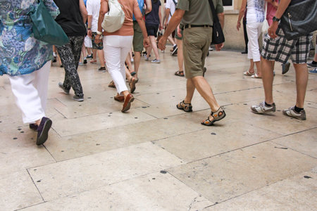Lots of people walking down the streetの写真素材