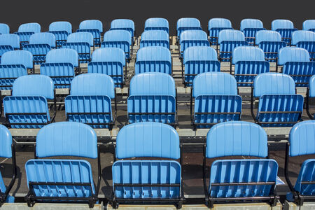 Blue plastic chairs at thetribune football stadiumの写真素材