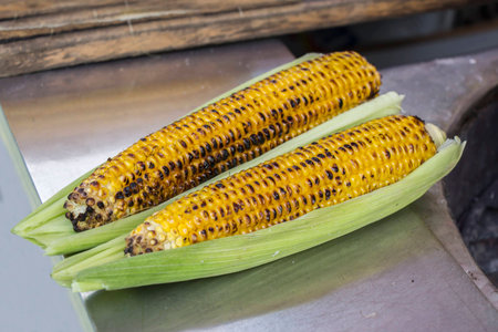 Grilled sweet corn cobs healthy and tasty meal の写真素材