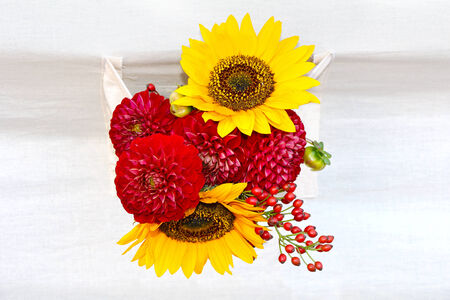 Autumn bouquet of sunflowers, chrysanthemums and rose hips の写真素材