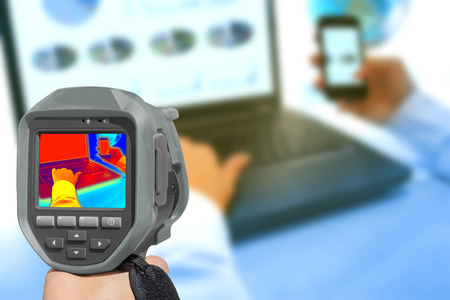 Recording With Infrared Thermal Camera heat and radiation of Notebook and smartphones in the officeの写真素材