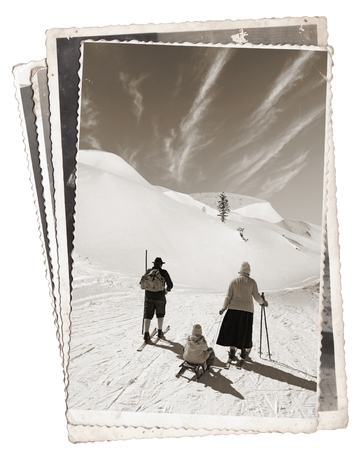 Vintage photos with Man and woman with old wooden skis and child on sledの写真素材