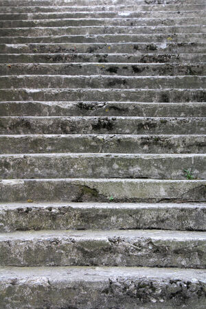 Old damaged stone staircase, up and down, textured backgroundの写真素材