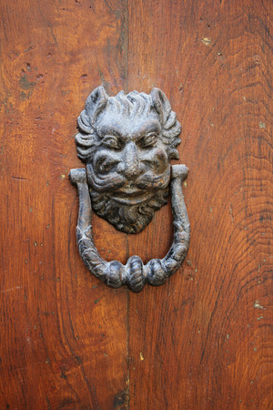 Old iron Door knoker on an old wodden doorの写真素材