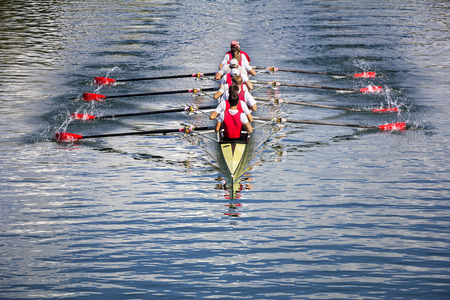 Rowers in eight-oar rowing boats on the tranquil lakeの写真素材