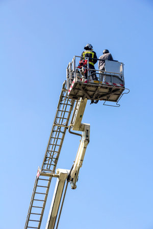 Ladder truck with firefighters and blue sky background