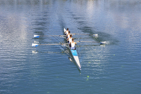 Rowers in four-oar rowing boats on the tranquil lakeのeditorial素材
