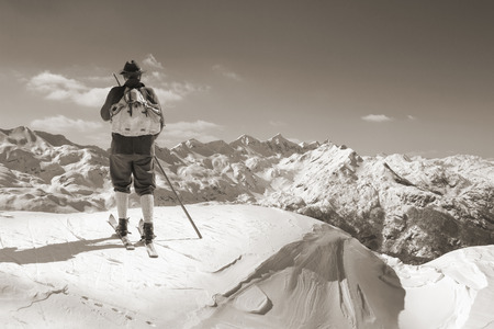 Old skier with traditional old wooden skis and backpackの写真素材
