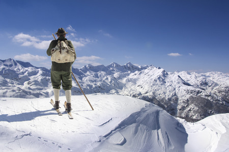 Old skier with traditional old wooden skis and backpackの写真素材