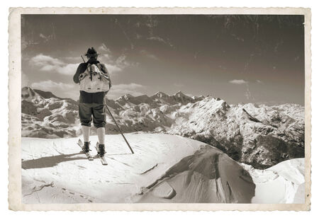 Vintage photo with old skier with traditional old wooden skisの写真素材