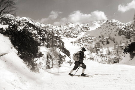 Vintage photos old skier with traditional old wooden skisの写真素材