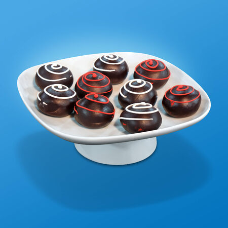 Chocolate balls Sweet dessert on a white bowl and a blue backgroundの写真素材