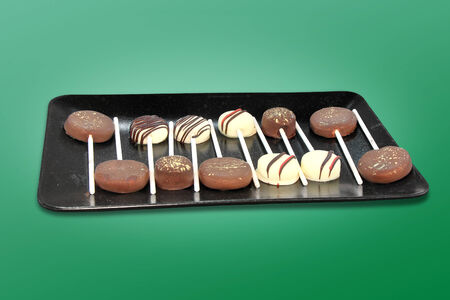 Chocolate candies on a stick tasty and sweet dessertの写真素材
