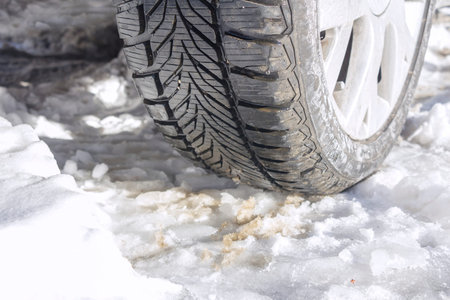 Winter tyres of a cars on a snowy road