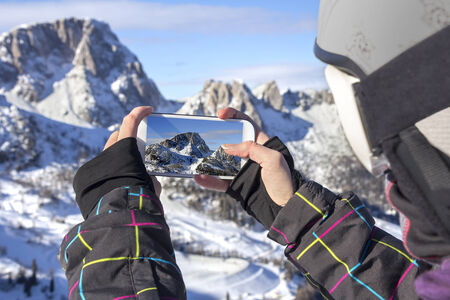 Photographing winter landscape mountains and snow, with cell phoneの写真素材