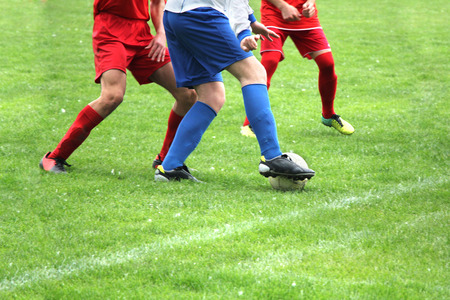 Soccer or football players in action on the field, blurred in motionの写真素材