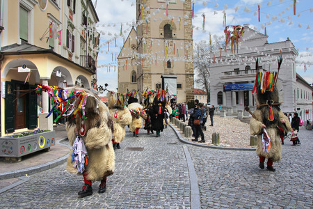 PTUJ, SLOVENIA - MARCH 1: Kurent is Slovene old traditional carnival mask with bells and dressed in fur. They chasing away the winter and calling spring. Ptuj, Slovenia March 1, 2014.のeditorial素材