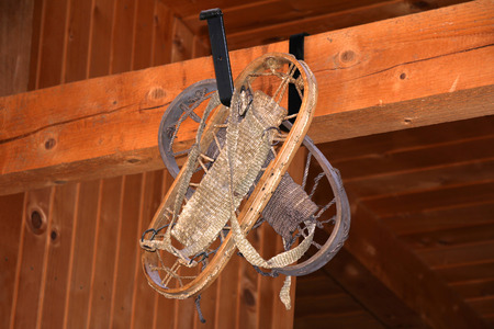 Old wooden Snowshoe on Wood Wall in a Mountain houseの写真素材