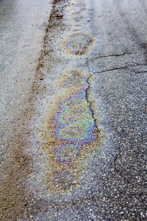 Oil spill on asphalt road as texture or backgroundの写真素材