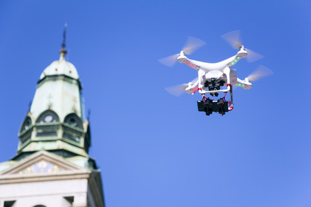 Radio controlled quadcopter drone flying in the blue skyの写真素材