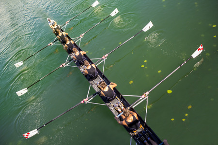 Boat coxed eight Rowers rowing on the tranquil lakeのeditorial素材