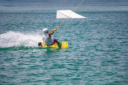 A young wakeboarder in action on the lake
