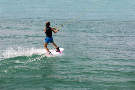 Young girl wakeboarder in action on the lakeの写真素材
