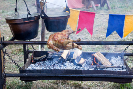 Rotisserie Chicken traditional way on skewer in natureの写真素材