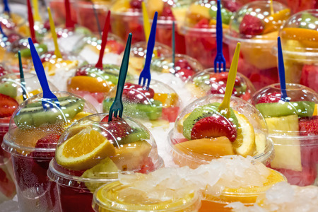 Fresh Fruit cocktail salad in plastic cups on a market stallの写真素材