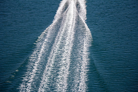 Trail on sea surface behind of speed boats