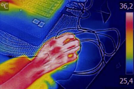 Infrared thermography image showing the heat emission when woman used notebookの写真素材