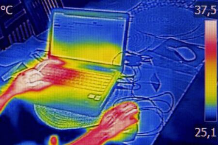 Infrared thermography image showing the heat emission when woman used notebookの写真素材
