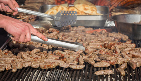 Grilling cevaps or kebabs on a grill at the street market
