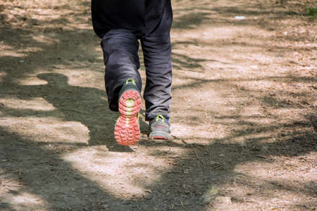 Man walking cross country and trail in forestの写真素材