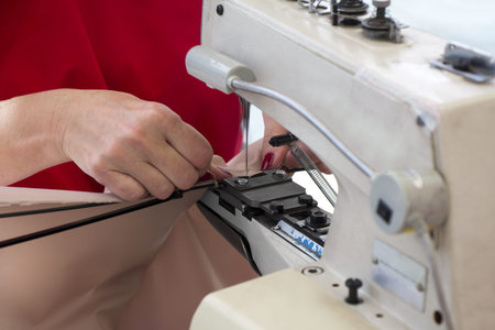 Woman's hands during sewing with sewing machine