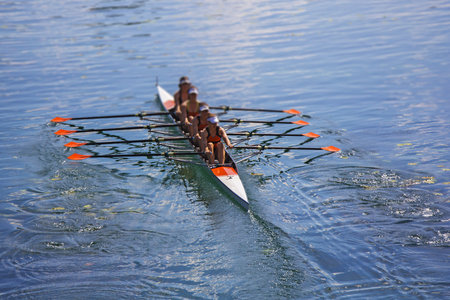 Team of rowing Four-oar women in boat 