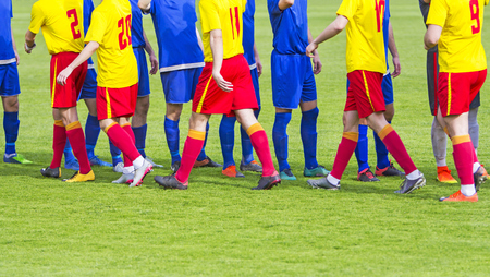 Two soccer team handshake on field before the football gameの写真素材