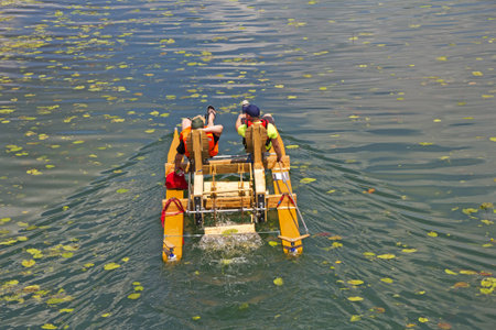 Two man ride with floating pedal bicycle boats across the lake