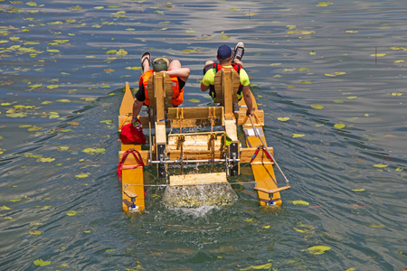 Two man ride with floating pedal bicycle boats across the lake
の写真素材