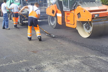 Construction workers on asphalting and road repairの写真素材